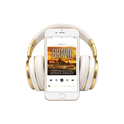 White and gold headphones with a smartphone displaying an audiobook titled 'Bravo' by Jessica Ashley.